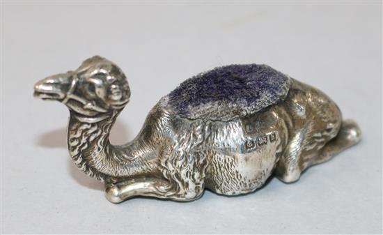 A silver camel pin cushion